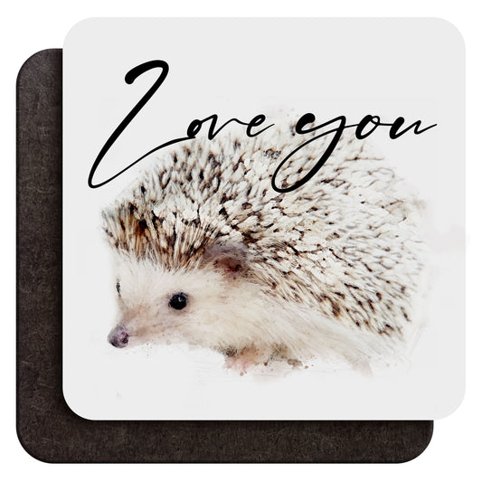 A 9 cm wood coffee coaster shown from both sides, with a watercolour hedgehog art print and custom cursive text saying ‘Love you’ as an example on one side and dark wood backing on the other, shown against a white background