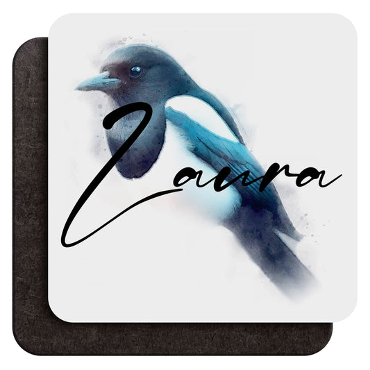 A 9 cm wood coffee coaster shown from both sides, with a watercolour blue magpie art print and custom cursive text saying ‘Laura’ as an example on one side and dark wood backing on the other, shown against a white background