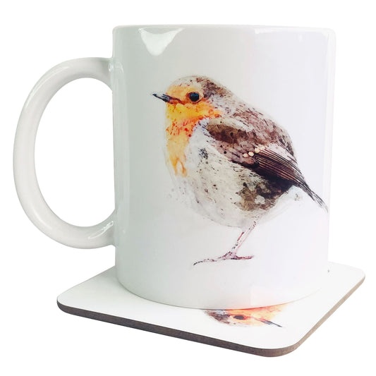 A glossy white ceramic mug with a watercolour robin bird art print on top of a wooden coaster featuring a matching print, shown against a white backdrop.
