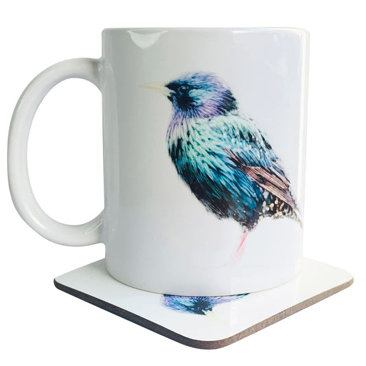 A glossy white ceramic mug with a watercolour starling bird art print on top of a wooden coaster featuring a matching print, shown against a white backdrop.
